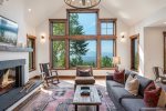 Northwest meets elegance in this upscale living room with massive windows